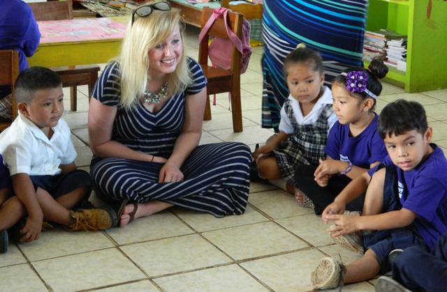 Nakita Gavre, a student from Harned, Ky., interacts with pre-school students in a classroom in  Belize during spring break in March 2015.