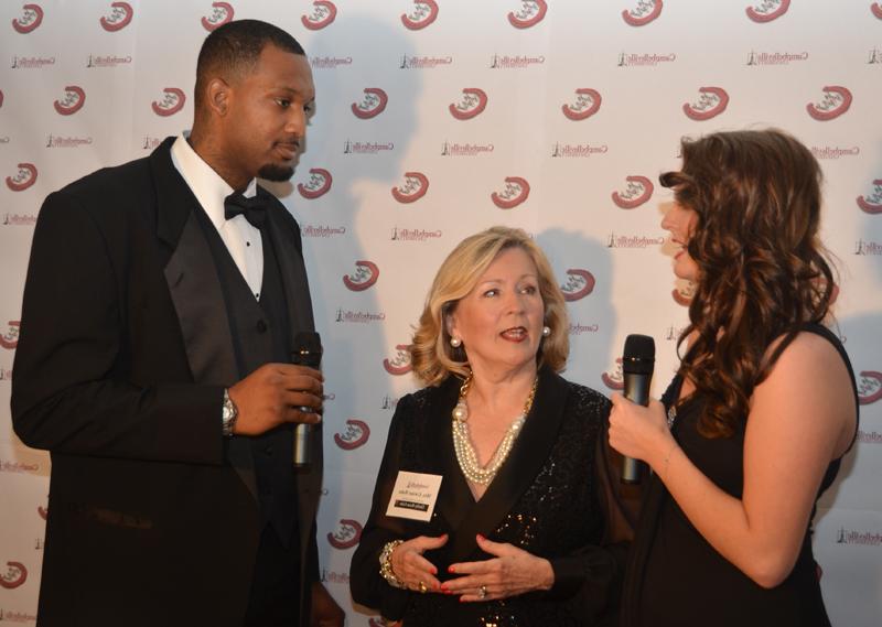 Kinly Bertram, left, and A'Darius Pegues, right,  interview Gwinn Hahn, chair of the gala, during the live broadcast. (Campbellsville University Photo by Bethany Thomaston)