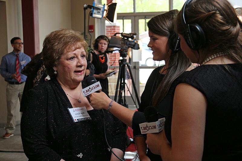 Students were a big part of the Derby Rose Gala. From shooting photography and video to interviewing guests. Interviewing Sara Curry, right, chair of the Advancement Board, is Shelby Knuckles, left, and Meg Brown. (Campbellsville University Photo by Drew Tucker)